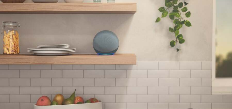 An Alexa Echo device sits on a kitchen shelf waiting to be used.