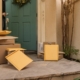 Several packages are right at a door decorated by a Christmas wreath.